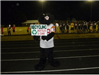 High School Mascot poses with Recycle Cans and Bottles sign